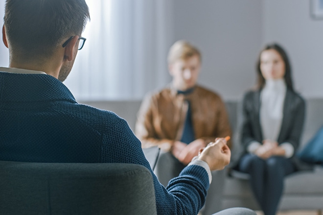 Unfocused Couple On Counseling Session With Psychotherapist. Foc