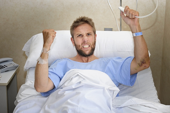 Angry Patient Man At Hospital Bed Pressing Nurse Call Button