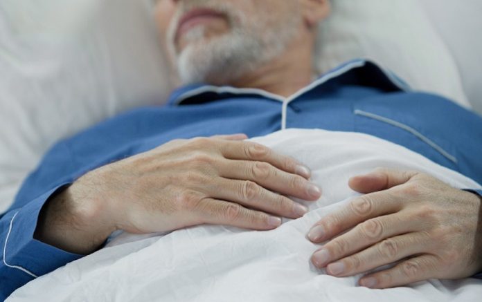 View Of Overworked Wrinkled Hands Of Wise Old Man Peacefully Drowsing In Bed