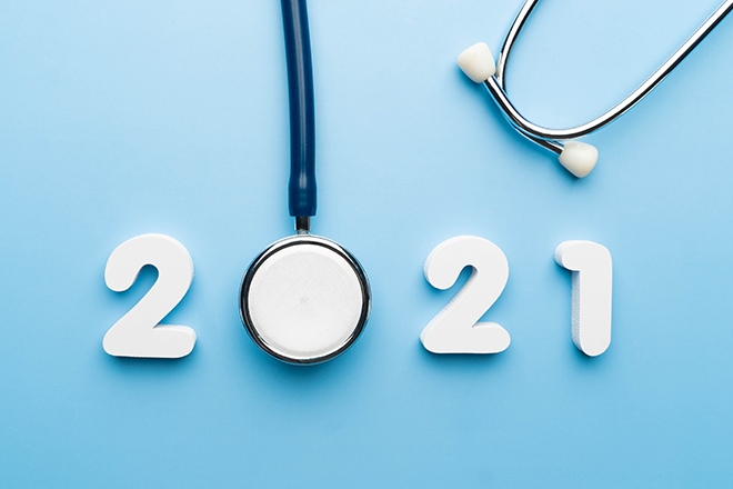 Stethoscope With 2021 Number On Blue Background. Happy New Year