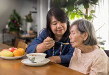Daughter Feeding Elderly Mother With Soup.