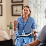 Psychologist having session with seniors at care facility centre