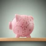 Piggy bank with pork cuts on shelf